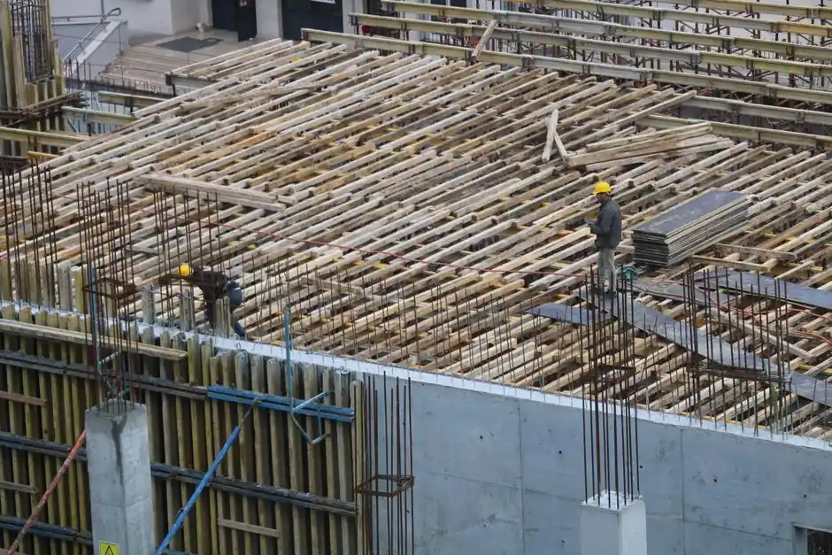 Men working on a construction site in Istanbul, with visible rebar and reinforcement structures.